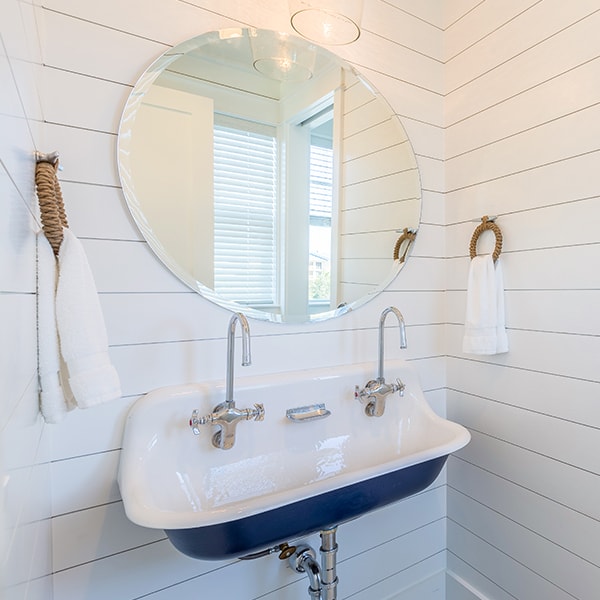 Sugar Beach Interiors, Miramar Beach, Florida. White coastal bathroom with vintage sink